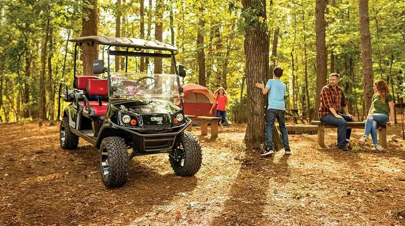 A black off-road golf cart with red seats.