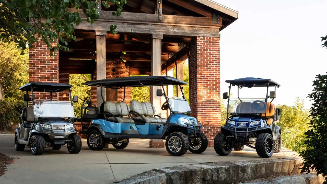 Three golf carts of different sizes and colors.